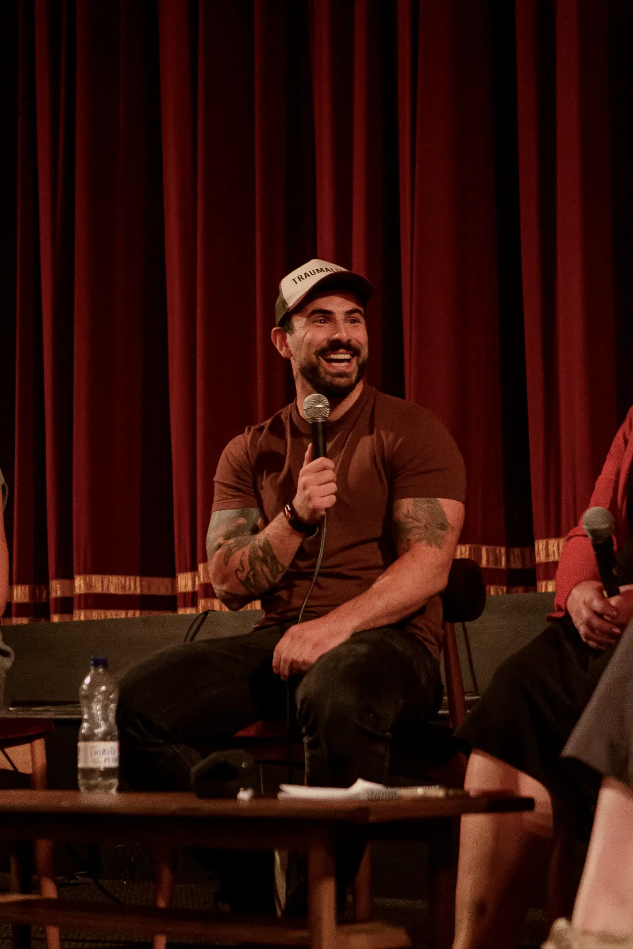 Ton Mazzone laughing with a microphone during the Brighton panel